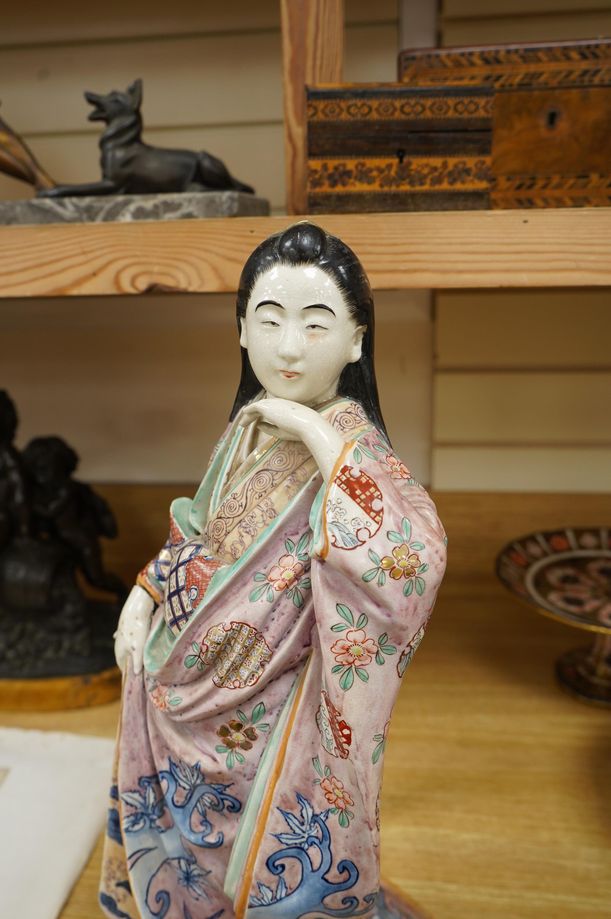 A Japanese earthenware figure of a lady, circa 1900, 46cm. Condition - poor